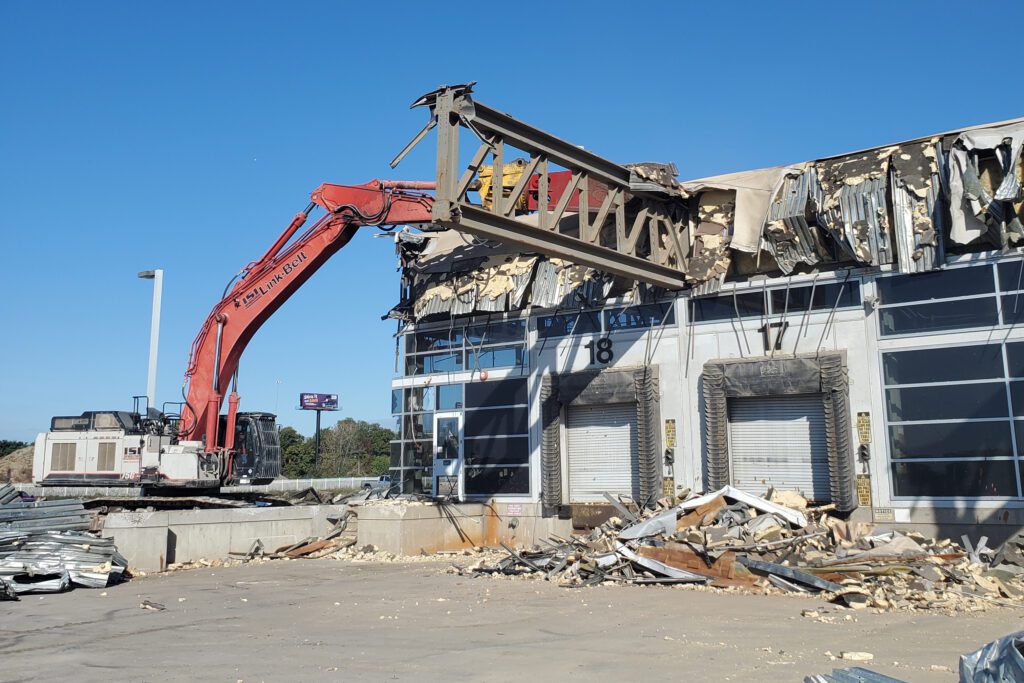 Excavator doing demolition at Baltimore Sun building in Baltimore Penisula