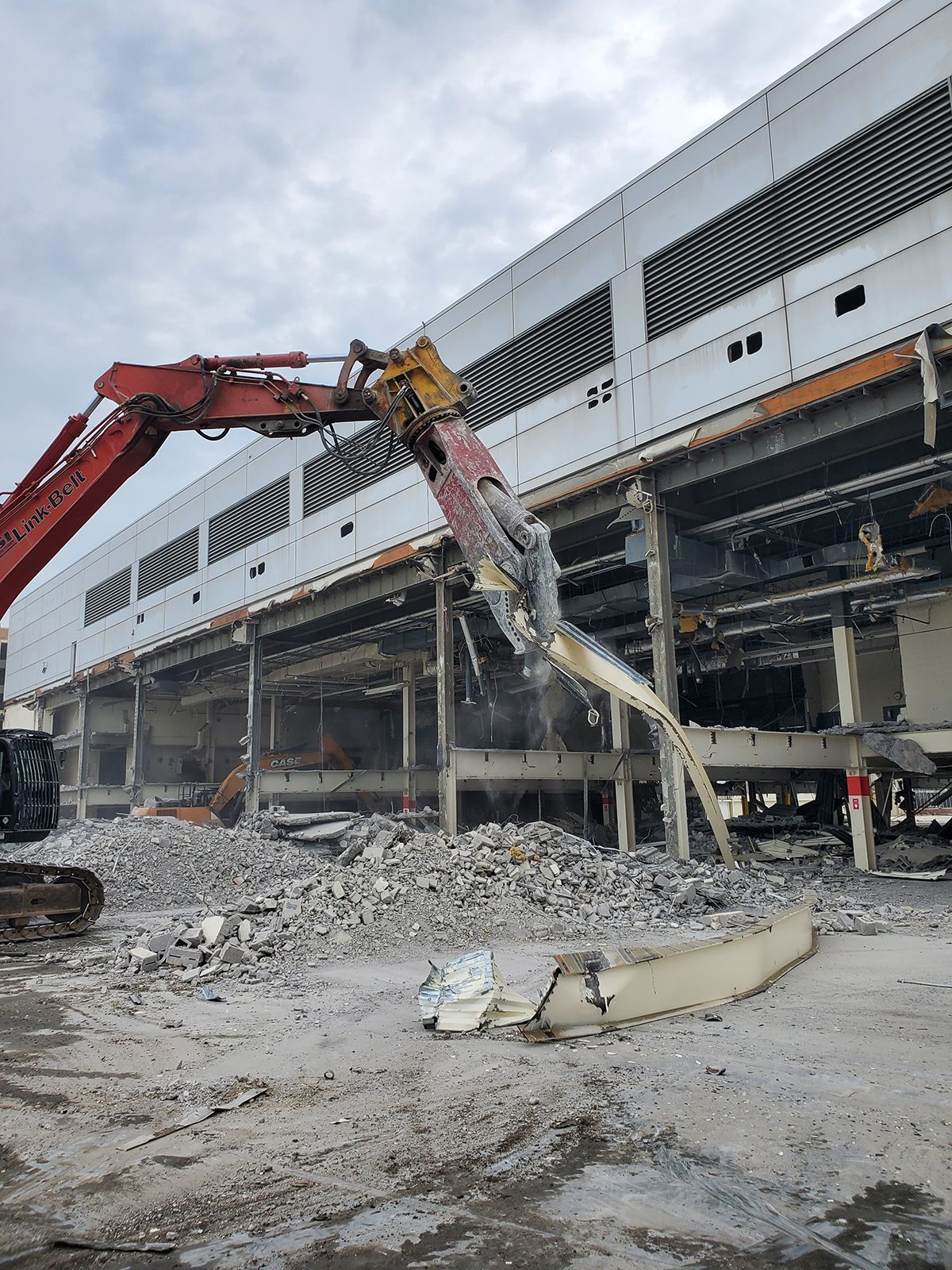 Metal shears attachment on excavator during building demolition