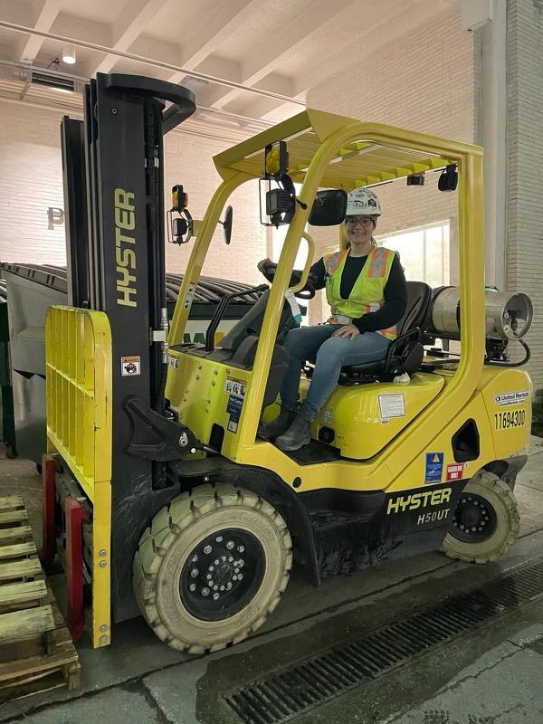 Female construction worker driving a forklift