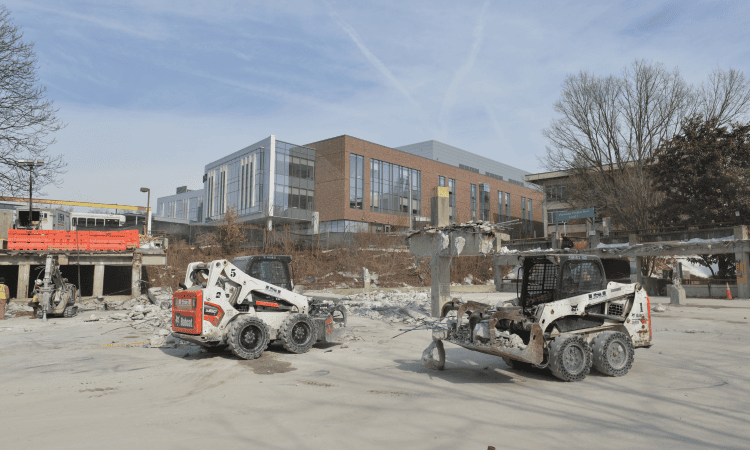 Bobcats clearing debris after the removal of a parking garage